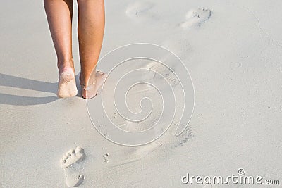 Tanned legs on the beach Stock Photo