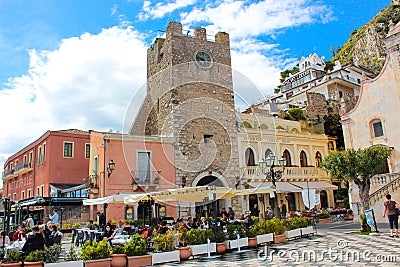 Taormina, Sicily, Italy - Apr 8th 2019: People sitting in outdoor restaurants and cafes on beautiful Piazza IX Aprile square Editorial Stock Photo