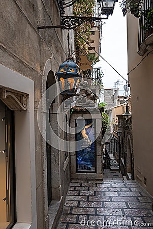 Illuminated lantern hanging outside old building in alley with sky in background Editorial Stock Photo