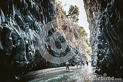 Tourists walking in Alcantara Gorge and Alcantara river park in Sicily Island, Italy. Editorial Stock Photo