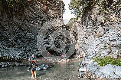 Tourists walking in Alcantara Gorge and Alcantara river park in Sicily Island, Italy. Editorial Stock Photo