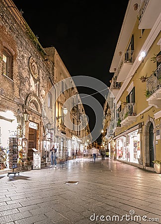 Taormina Sicily, old streets of Taormina during evening with the lights on and people on the terrace Editorial Stock Photo