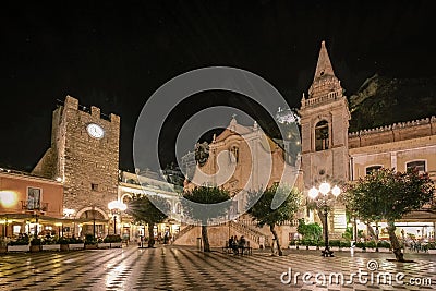 Taormina Sicily, old streets of Taormina during evening with the lights on and people on the terrace Editorial Stock Photo