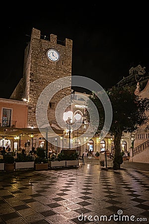 Taormina Sicily, old streets of Taormina during evening with the lights on and people on the terrace Editorial Stock Photo