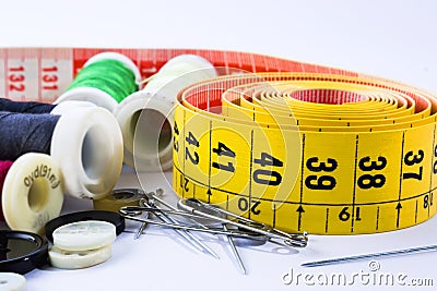 Tape measuring and spools of threads backgroun white Stock Photo