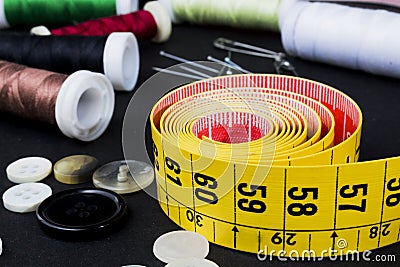 Tape measuring and spools of threads Stock Photo