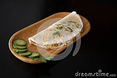 Tapioca Brazilian food on wooden plate black isolation space poster background wallpaper concept for cafe or restaurant menu with Stock Photo