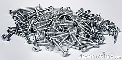 Tapping screws made od steel, metal screw, iron screw, chrome screw, as a background, wood Stock Photo