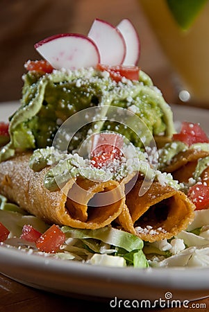 Taquitos and guacamole Stock Photo