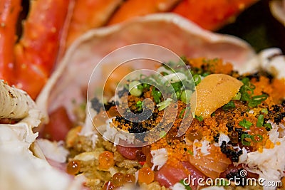 Taraba fried rice in the crab shell consists of tobiko, Ikura roe, salmon and tuna sashimi. Japanese seafood Stock Photo
