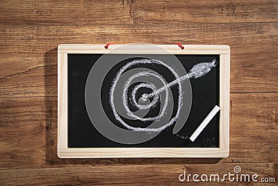 Target and arrow on small chalkboard. Goals. Success Stock Photo