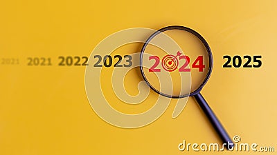 Target of business concept. magnifier focusing on the year 2024. Focus on new business goals, plans, and strategies of the year Stock Photo