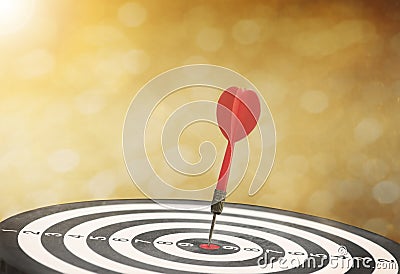 Target red arrow center of dartboard blurred bokeh background. Stock Photo