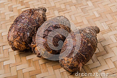 Taro roots , bamboo basket. Stock Photo