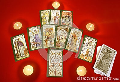 Tarot cards with candles on red textile Stock Photo