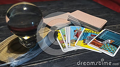 Tarot cards and magic ball on wooden background. Mystical and divination concept Stock Photo