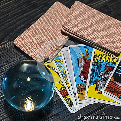 Tarot cards and magic ball on wooden background. Mystical and divination concept Stock Photo