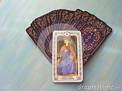 Tarot cards medieval close up with russian title The Empress Tarot Decks on blue wooden background Stock Photo