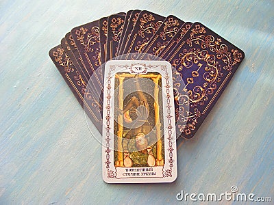 Tarot cards medieval close up with russian title The Hangedman, The Hanged Man Tarot Decks on blue wooden background Stock Photo