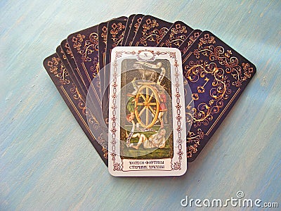 Tarot cards medieval close up with russian title Wheel of Fortune Tarot Decks on blue wooden background Stock Photo