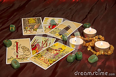 Tarot cards with runes and burning candle Editorial Stock Photo