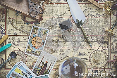 Tarot cards on the world vintage map for fortune and travel concept. Flay lays with Stock Photo