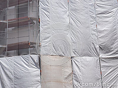 Tarpaulin on a scaffolding construction site Stock Photo