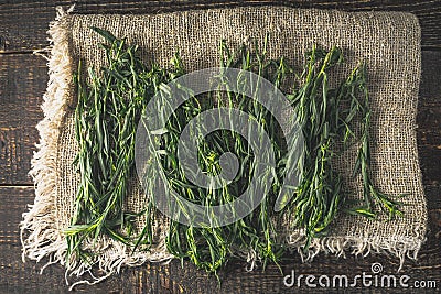 Tarragon on the canvas on the wooden table top view Stock Photo