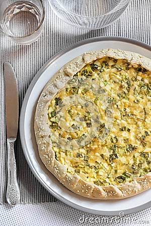 Tart with eggs and green onions on a plate Stock Photo