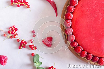 Tart, pie, cake with jellied and fresh raspberry on the light concrete background. Stock Photo