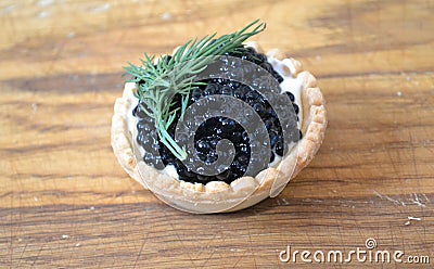Tartlet with butter and black caviar Stock Photo