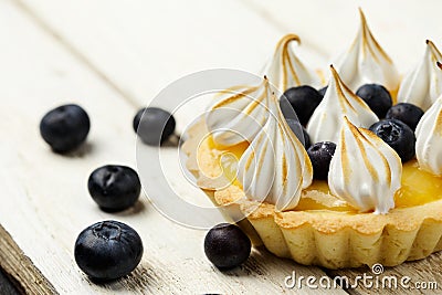 Tartlet with lemon curd, blueberries and meringue Stock Photo