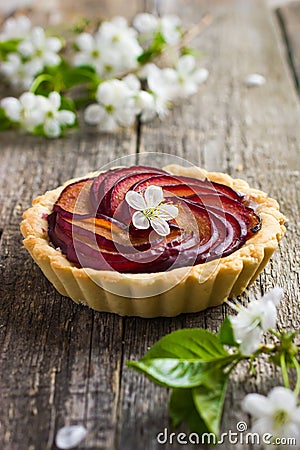 Tartlet with plum on wooden background Stock Photo