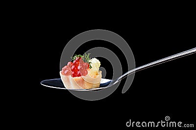 Tartlet with red caviar and butter and dill on a tablespoon on a Stock Photo