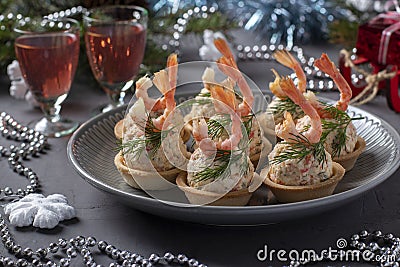 Tartlets with crab sticks, cheese and shrimps in the New Year`s composition. Delicious festive snack. Closeup Stock Photo