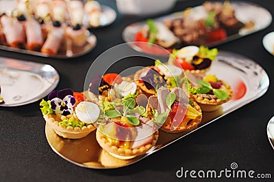 tartlets with pate and salad garnished with flowers. Delicious appetizers. Stock Photo