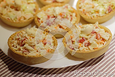 Tartlets with snack on white plate Stock Photo