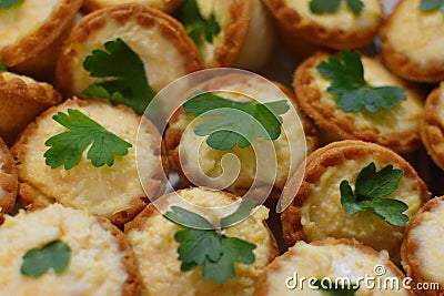 Tartlets from the test with cheese and greens Stock Photo