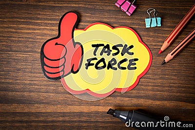 Task Force. Sticky note with text on wooden texture office table Stock Photo