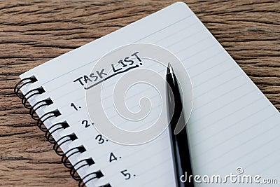 Task List, project management concept, pen on white paper notepad with handwritten headline as Task List and numbers listed on Stock Photo