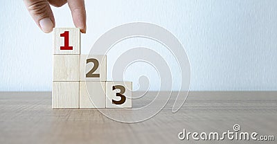 Task priority and management concept, Hand arranging Wooden cube blocks with number first, second, third Stock Photo