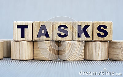 TASKS - word on wooden cubes on a beautiful gray background Stock Photo