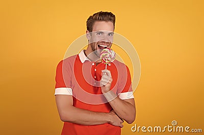 Taste of childhood. Happy eating sweets. Symbol of happiness. Man eat lollipop. Man smiling hold lollipop. Holiday Stock Photo
