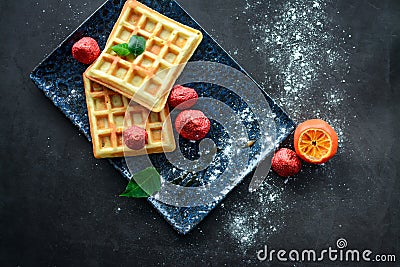 Tasteful Belgian waffles and dried strawberries for breakfast Stock Photo