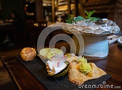 Tasting of caviar and salmon eggs with blinis, potatoes and cream puffs Stock Photo