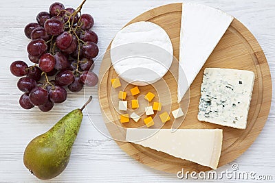 Tasting cheese with fruits on a white wooden background. Food for wine, top view. Flat lay. Stock Photo