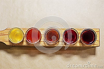 tasting of colorful fruit and berry liqueurs on a craft background. Stock Photo