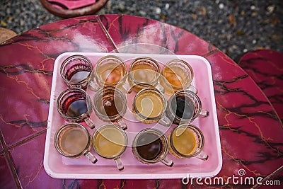 Tasting pack of twelve cups of indonesian coffee and tea brewed in different ways. Bali Stock Photo