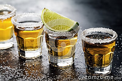 Tasty alcohol drink cocktail tequila with lime and salt on vibrant dark background. Closeup. Horizontal. Stock Photo