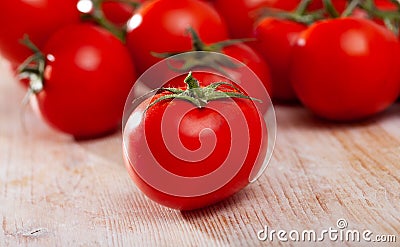 Tasty appetizing tomatoes on a wooden surface Stock Photo